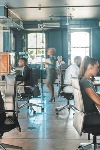 Corporate business people working in busy marketing office space, planning strategy in books and re.